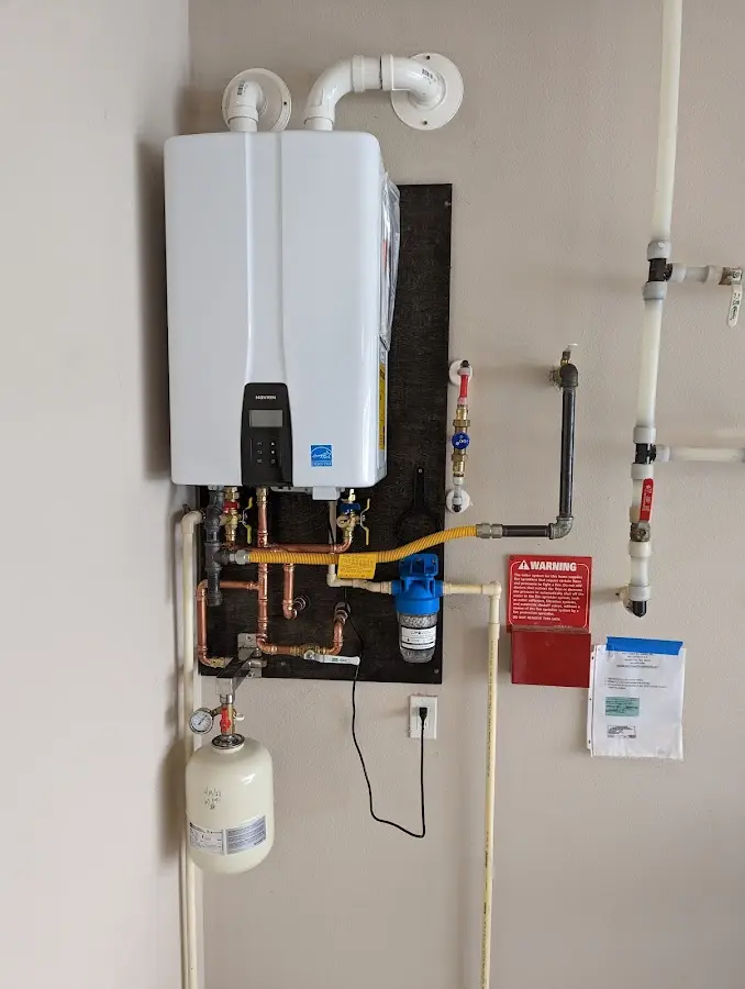 Professional plumber installing copper piping in a Walled Lake home